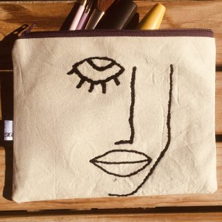 Many faces canvas purse.