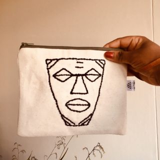Many faces African mask hand embroidered canvas mask.
