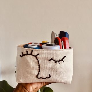 One line canvas hand embroidered fabric pot.